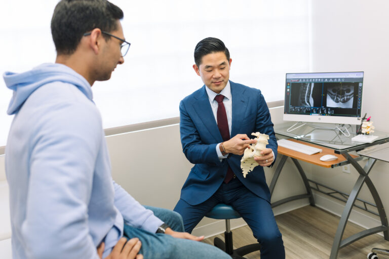 Dr. Daniel Choi explaining cervical disc replacement versus fusion surgery for patients with neck pain and cervical disc disease.